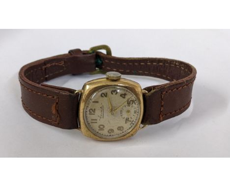 An early 20th century Everite 9ct gold manual wind wristwatch on a brown leather strap, Location: 