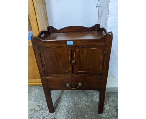 A Georgian mahogany tray topped bedside commode, twin cupboard doors with inlaid stringing above a single drawer, on square l