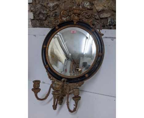 A 19th century gilt gesso wood and black girandole mirror, circular frame surmounted by scrolled leaf and urn decoration, sli