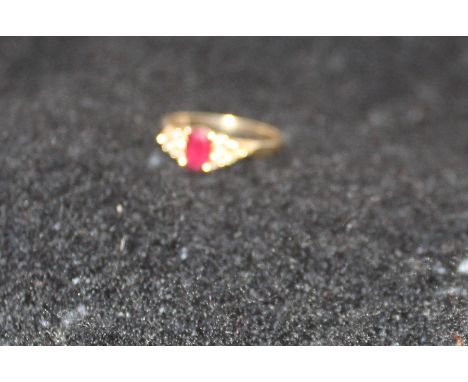 A 9ct. gold, ruby and diamond ring, set oval cut ruby to centre and six round cut diamonds to each shoulder, (gross weight 2.