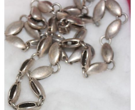 A collection of modernist silver jewellery, to include; a silver necklace and bracelet en suite, each fashioned from brushed 