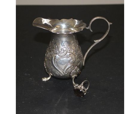 A silver cream, by Joseph Gloster Ltd, assayed Birmingham 1973, the side repousse flowers and 'C' scrolls, raised upon triple