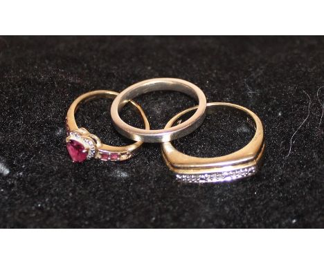 A silver gilt dress ring, set row of small round cut diamonds, together with a silver band and a 9ct. gold dress ring, set he