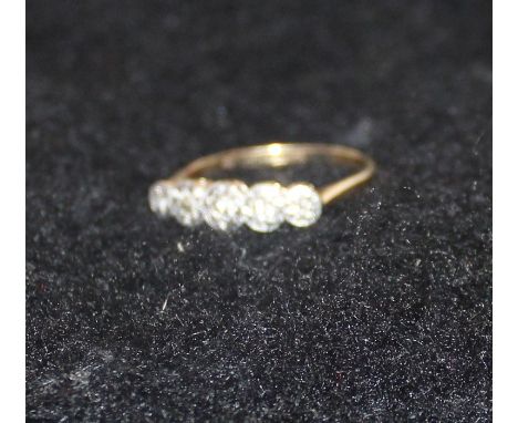 An 18ct gold and five stone diamond ring, illusion set row of five graduated round old cut diamonds, shank stamped "18 &amp; 