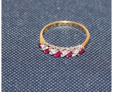 An 18ct. gold, diamond and ruby ring, set four pairs of round cut diamonds alternating five single baguette cut rubies, impor