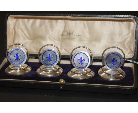 A boxed set of four silver and enamel place settings, by Henry Clifford Davis, assayed Birmingham 1911, of circular form with
