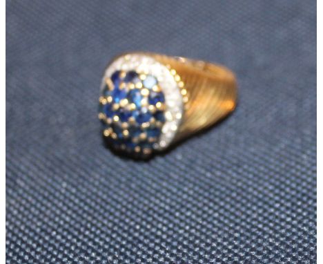 A precious yellow metal, sapphire and diamond dress ring,&nbsp;with central curved tear drop mount pave set numerous sapphire