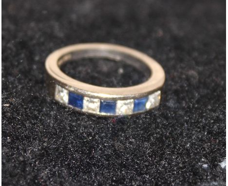 An 18ct. white gold, sapphire and diamond ring, set four princess-cut diamonds alternating three square cut sapphires, hallma