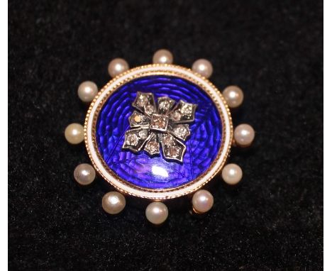 A Victorian yellow metal, enamel, diamond and seed pearl circular mourning brooch,&nbsp;having dark blue guilloche enamel wit