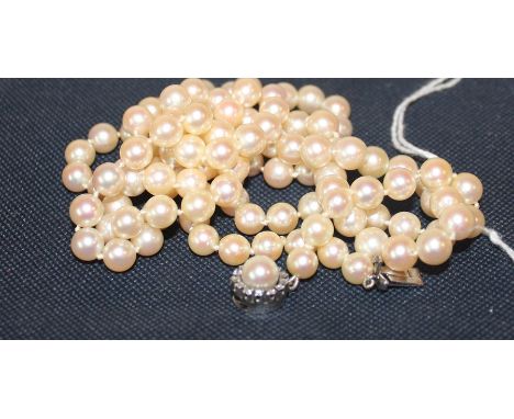 A cultured pearl necklace, with cultured pearl and diamond set precious white metal clasp clasp, (white metal assessed as 18c