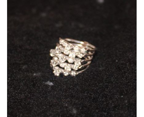 A white metal and diamond dress ring, set twenty-five round brilliant cut diamonds to five separate bands hinged at base, (ap