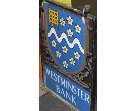 A cast iron and enamel Westminster bank sign, with two double sided polychrome enamelled panels, one shield shaped with Westm
