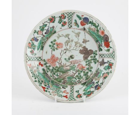 A Chinese Famille Verte Charger. Qing dynasty, Kangxi period the interior enameled with flowers and a bird, the rim with pane