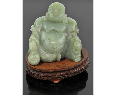 Large jade Buddha, holding a gourd in one hand and a rosary on the other hand. 12 cm high. Comes with a wooden stand.