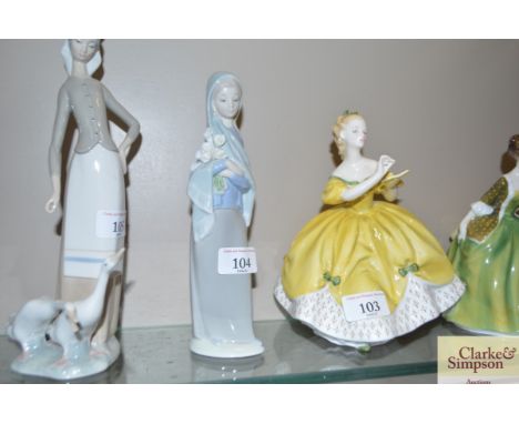 A Lladro figurine of a girl with an arm full of flowers