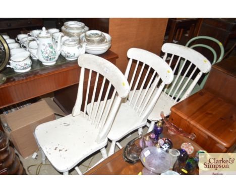 Three white painted stick back chairs together with a green painted bentwood chair