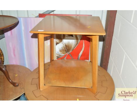 A light wood two tier occasional table 