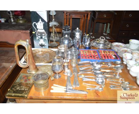 A large quantity of platedware including cutlery; tureen; teaware; a metalware lamp; a copper bugle etc