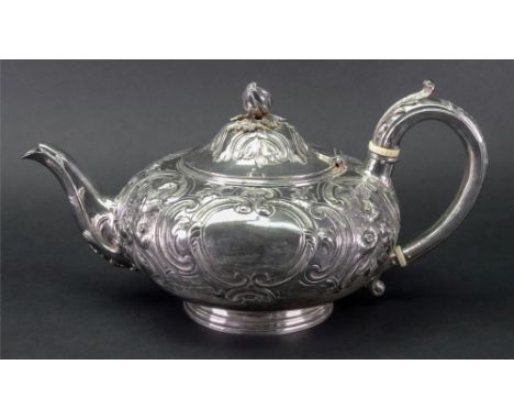 A Victorian compressed circular silver teapot, Joseph Angell, London 1854, embossed with flowers, leaves and 'c' scrolls agai