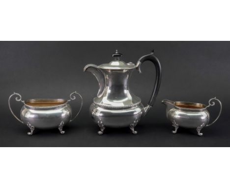 A Regency style three piece silver coffee service, J Gloster, Birmingham 1938 & 1939, of oval shape, with foliate borders, ea