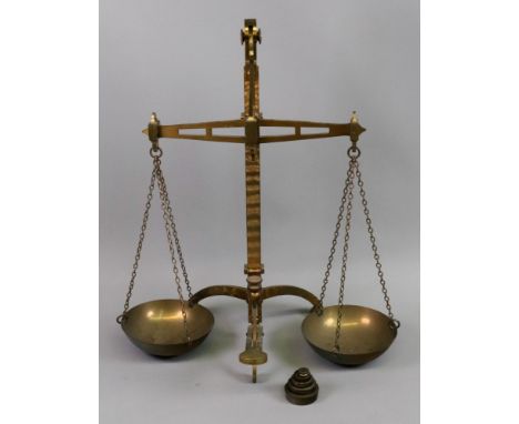 A set of brass beam scales, Degrave &amp; Co makers London, with circular pans, on a tripod base, 55cm high and a set of six 