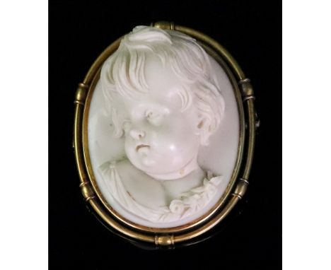 A 19th century gold mounted, oval marble cameo brooch, European circa 1870, designed as the portrait of a child, with a flora