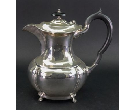 A Regency style silver hot water pot, Emile Viner, Sheffield 1932, of lobed oval bulbous form, with blackwood scroll handle a