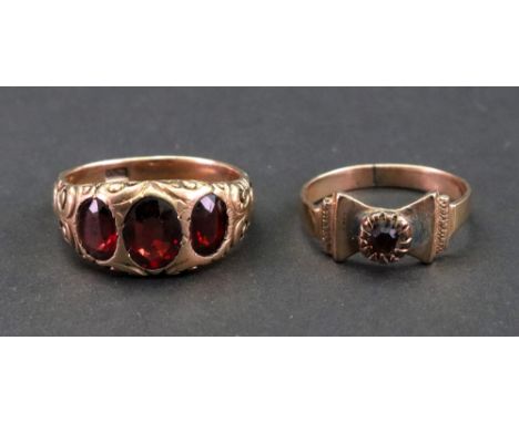A three stone garnet ring, detailed XV, the oval cut stones to a scroll carved shank, ring size U, and another single stone g