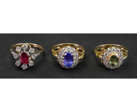 A collection of three gem set rings, comprising; a gold ruby and diamond cluster ring, detailed 18ct; an 18ct gold tanzanite 