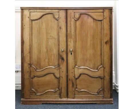 A pair of French provincial walnut shaped sunk panel doors, 19th century, enclosing a later cupboard with adjustable shelves,