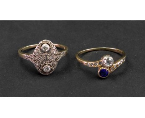 A diamond and sapphire ring, collet set with a cushion shaped diamond and with a cushion shaped sapphire, between rose diamon