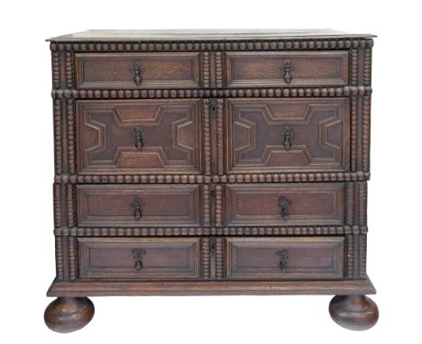 A late 17th century oak chest, in two parts, of panelled construction, the moulded rectangular top above four long block moul