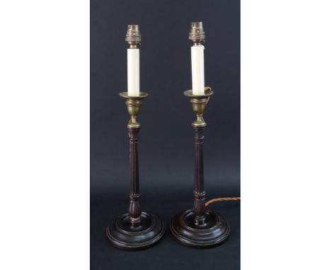 A pair of George III style mahogany candlestick table lamps, with reeded and ring turned columns and brass vase shape sconces