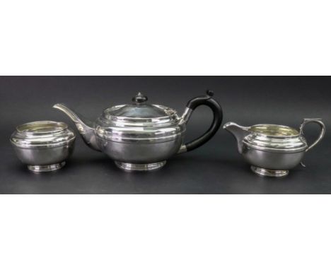 An Art Deco three piece compressed circular silver tea service, Goldsmiths &amp; Silversmiths Company, London 1935 Jubilee ma