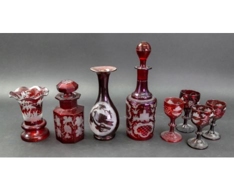 A collection of eight pieces of Bohemian ruby flashed glassware, 19th century, comprising: a vase etched with a landscape sce