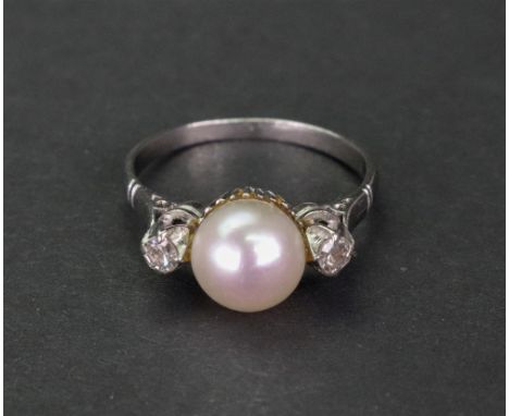 A white gold, cultured pearl and diamond ring, the cultured pearl set between two eight cut diamonds, ring size M, 3.68g gros