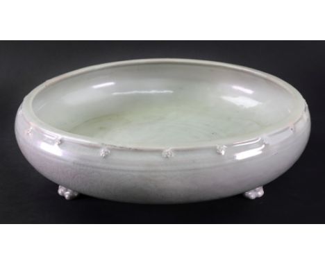 A large Chinese celadon glazed tripod censer, Ming dynasty or later, the shallow sides incised with foliate scrolls moulded s