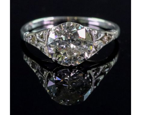 A diamond solitaire ring, the central old cut, approximately 2cts, within rose cut diamond set pierced millegrain soldiers, u