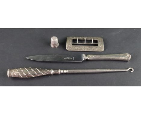 A late Victorian rectangular silver mounted steel buckle, Birmingham 1900, leafy scroll engraved, 7cm wide, a silver thimble,