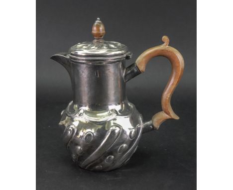 A late Victorian silver hot water pot, Edward Hutton, London 1893, in late 17th century style, the lower part embossed with c