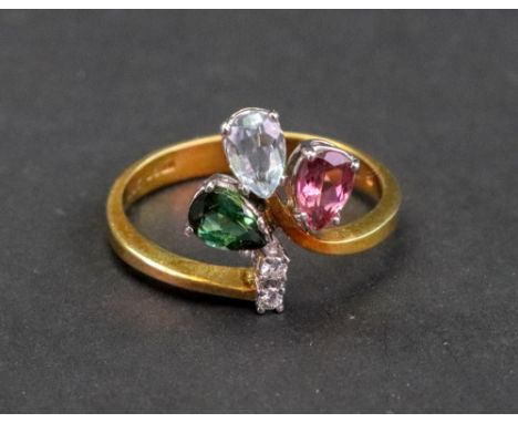 An 18ct gold, tourmaline and diamond set dress ring, claw set with three vari-colour pear shape stones and two diamond points