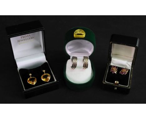 A pair of gold and citrine pendant earrings, each mounted with a heart shaped citrine, the tops with post fittings, a pair of