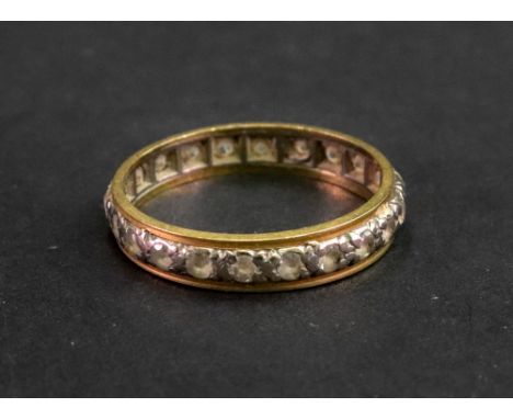A diamond set full eternity ring, the two colour shank detailed '18ct', ring size P, 3.2g gross.