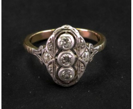 A diamond ring, in a pierced shaped oval panel, collet set with the three principal cushion diamonds to the centre, between s