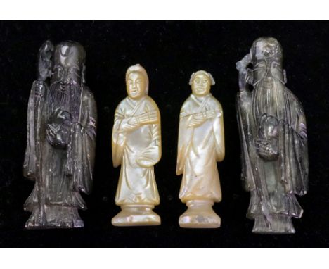 A near pair of Chinese carved mother of pearl standing figures, 19th century, each holding a fan, standing on canted corner r