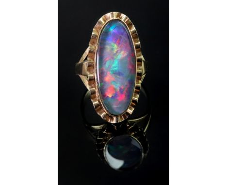 A gold ring, mounted with an oval opal doublet, within a wavy surround, between split shoulders, detailed 9 CT, ring size P, 