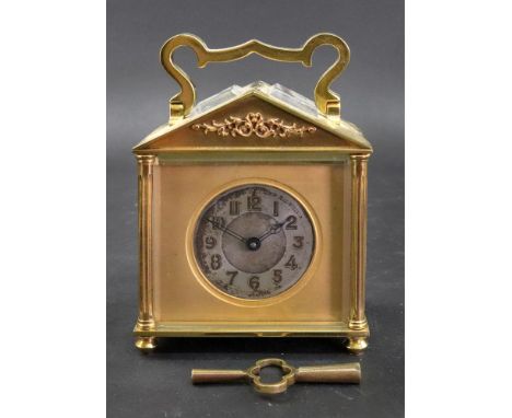 A French brass carriage timepiece, early 20th century, of architectural design, the silvered dial with Arabic numerals within