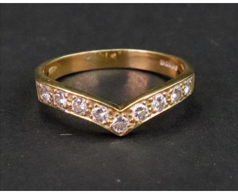 An 18ct gold and diamond wishbone ring, set with nine single cut diamonds, ring size Q 1/2, 3.1g gross.