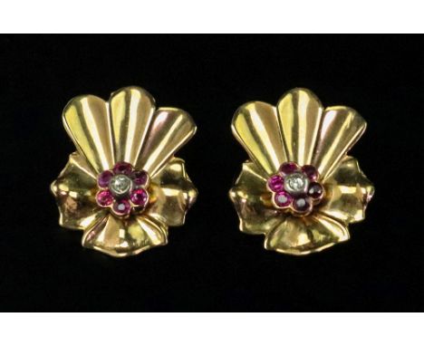 A pair of gold, ruby and diamond earclips, circa 1950, each in a stylized flowerhead design, mounted with a cushion shaped di