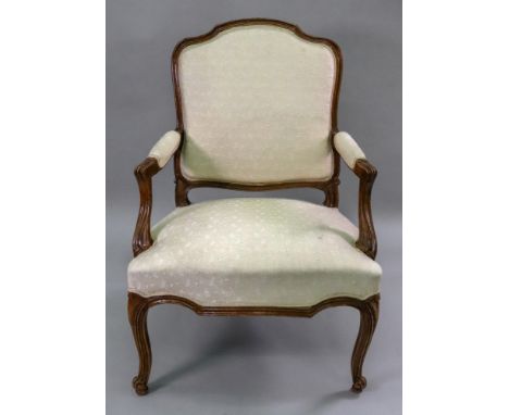 A Louis XV walnut fauteuil, the moulded frame with an arched upholstered back panel, manchettes and serpentine fronted stuff 